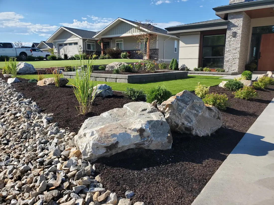 Natural granite boulders set into a landscaped bed, Shuswap BC