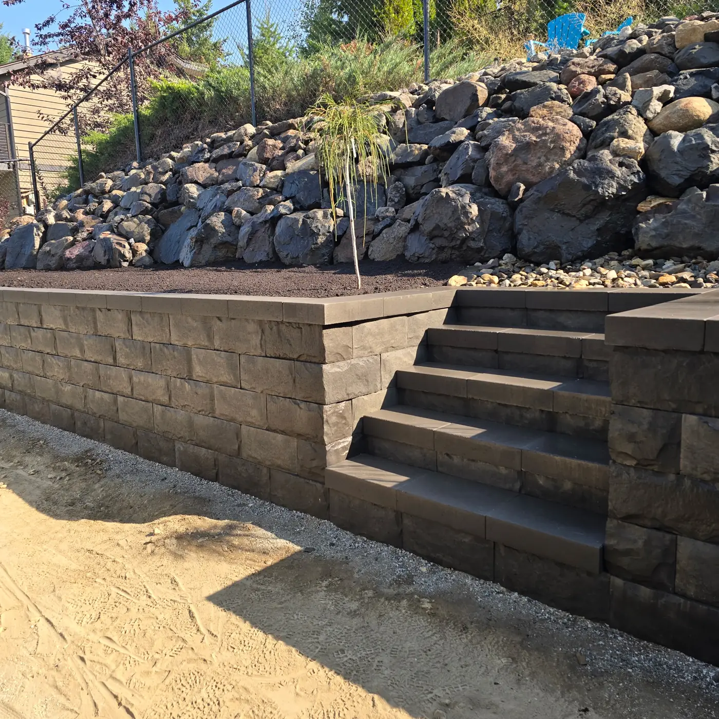 Engineered block retaining wall with matching steps and boulder rip-rap, Salmon Arm BC